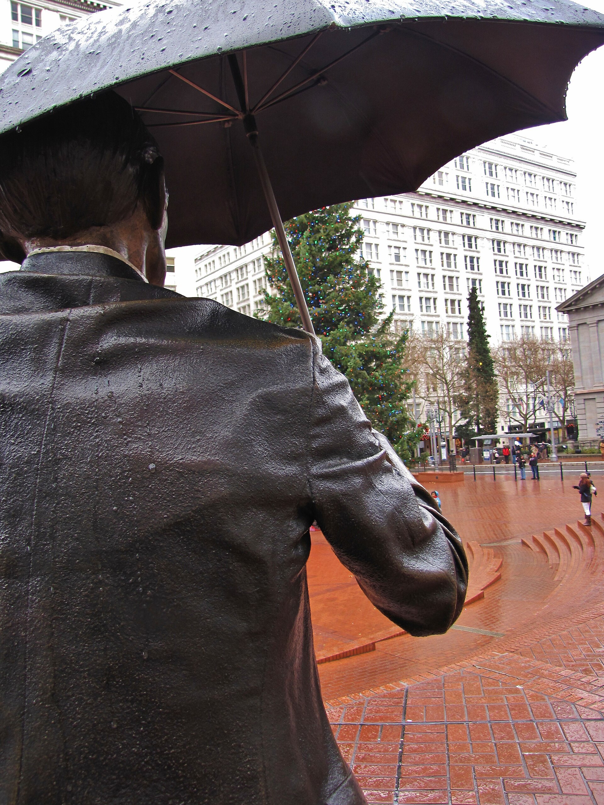Allow Me statue from behind