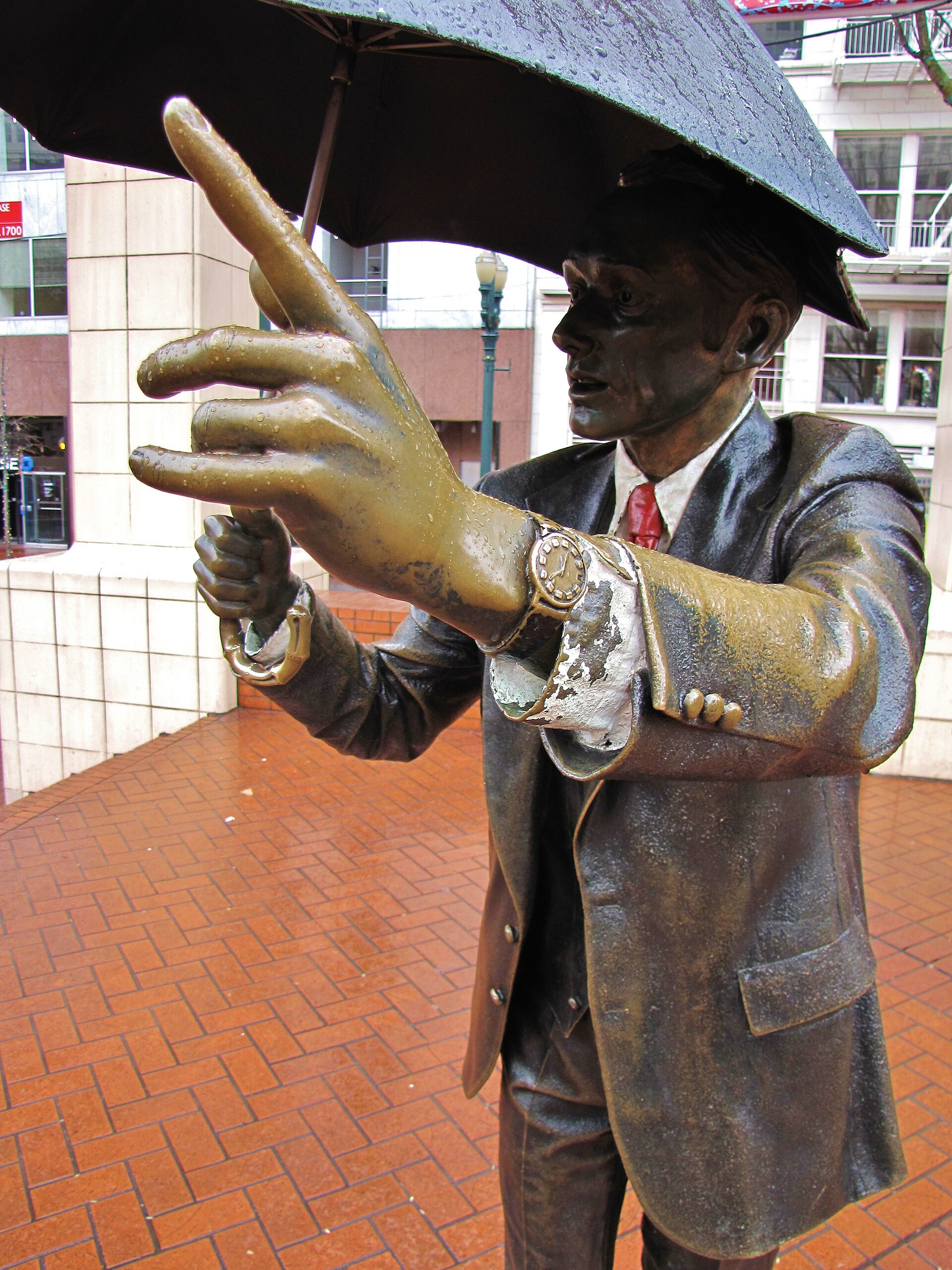 Allow Me umbrella man statue